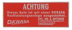 Schild Achtung Okrasa (95 x 38 mm).